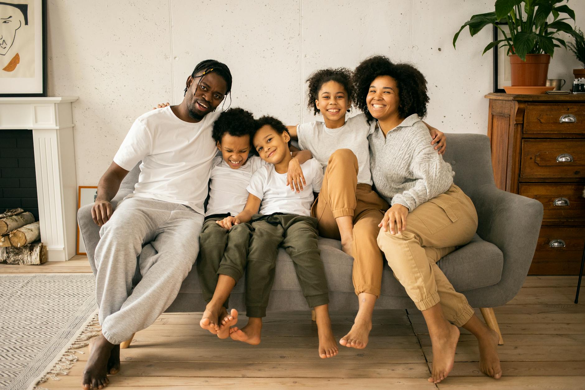smiling black family resting on couch